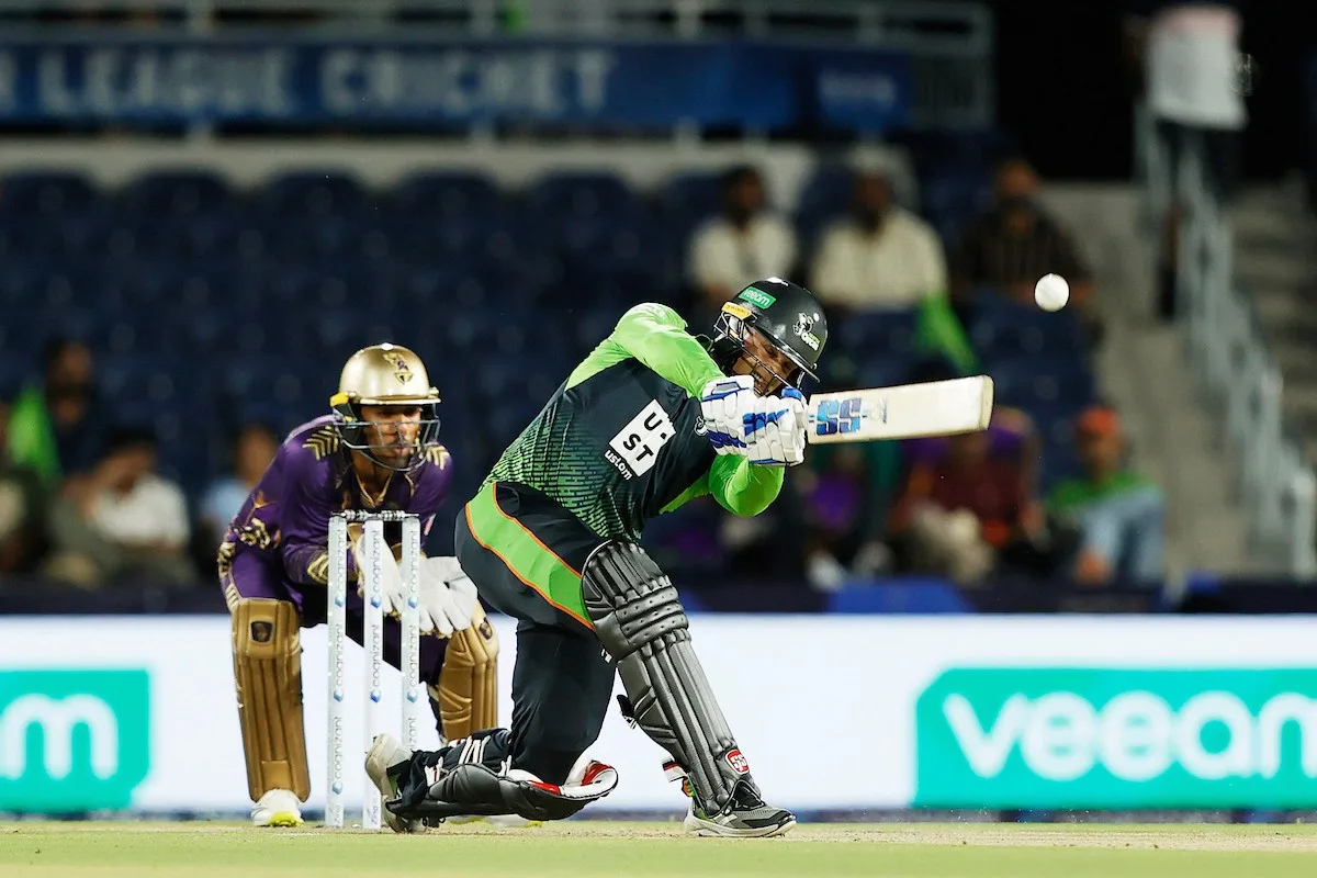 A batter and wicketkeeper during play